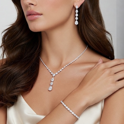 Closeup beautiful brunette girl with long hair in silver jewelry earrings, rings, bracelet and necklace in decollete. Сoncept gentle, elegant, delicate, romantic jewelry, bijouterie on model diamond necklace, earrings, and bracelet from a fine jeweler in houston
